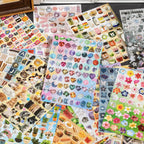 Mixed journaling sticker sheets with letters, flowers, gems, food, and animal designs
