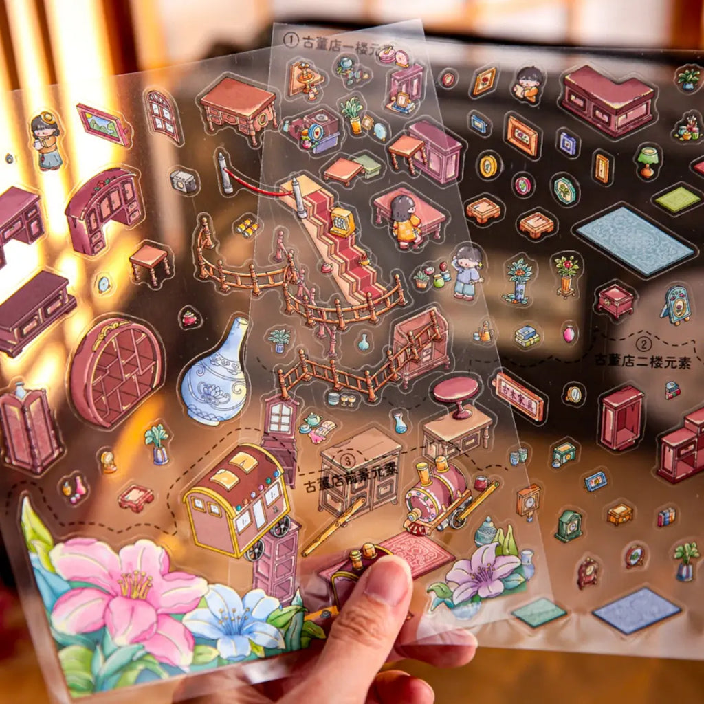 PVC sticker sheets for the Qiling Curio House 3D Scene Sticker Kit with furniture, cabinets, stairs, vases, and floral pieces