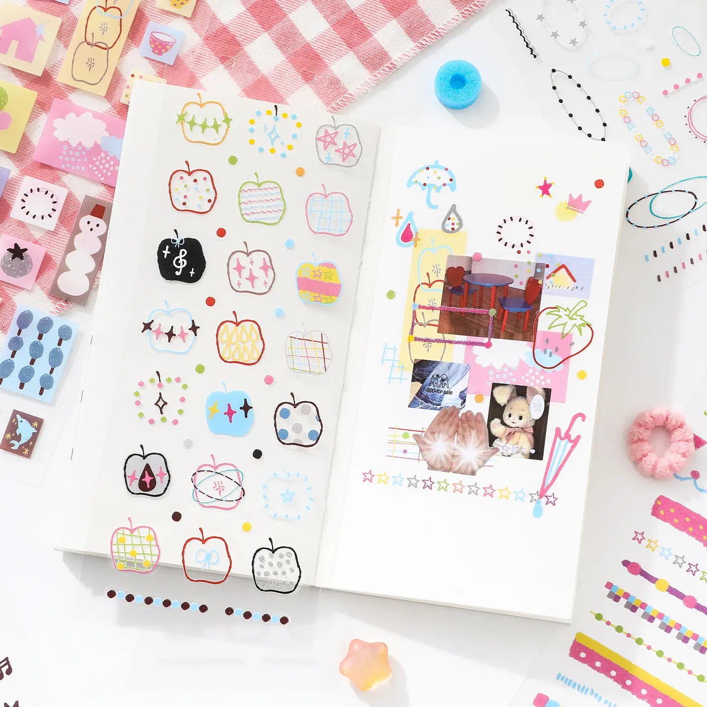 Open journal pages decorated with apple outline stickers, colorful dots, and collage-style Quiet Notes accents