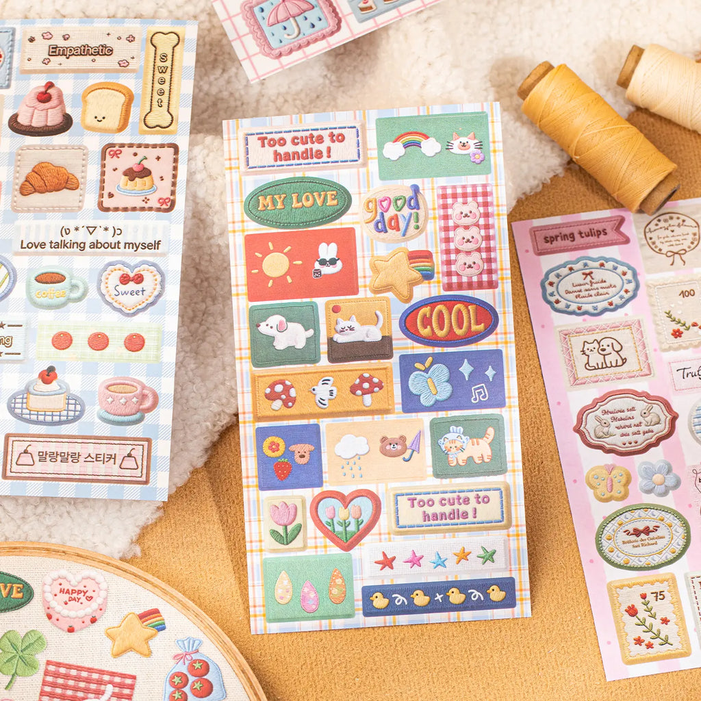 Rainbow Stitch sticker sheet with cats, dogs, rainbows, mushrooms, flowers, and decorative message labels