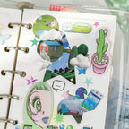 Close-up of a retro phone sticker with glossy texture held by tweezers