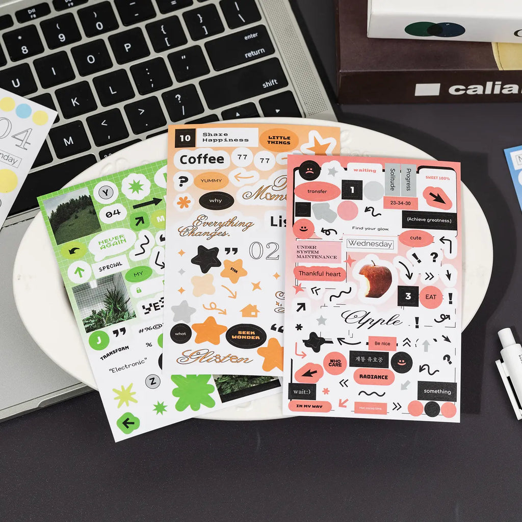 Graphic journaling sticker sheets with yellow, black, mint, arrows, labels, and word stickers