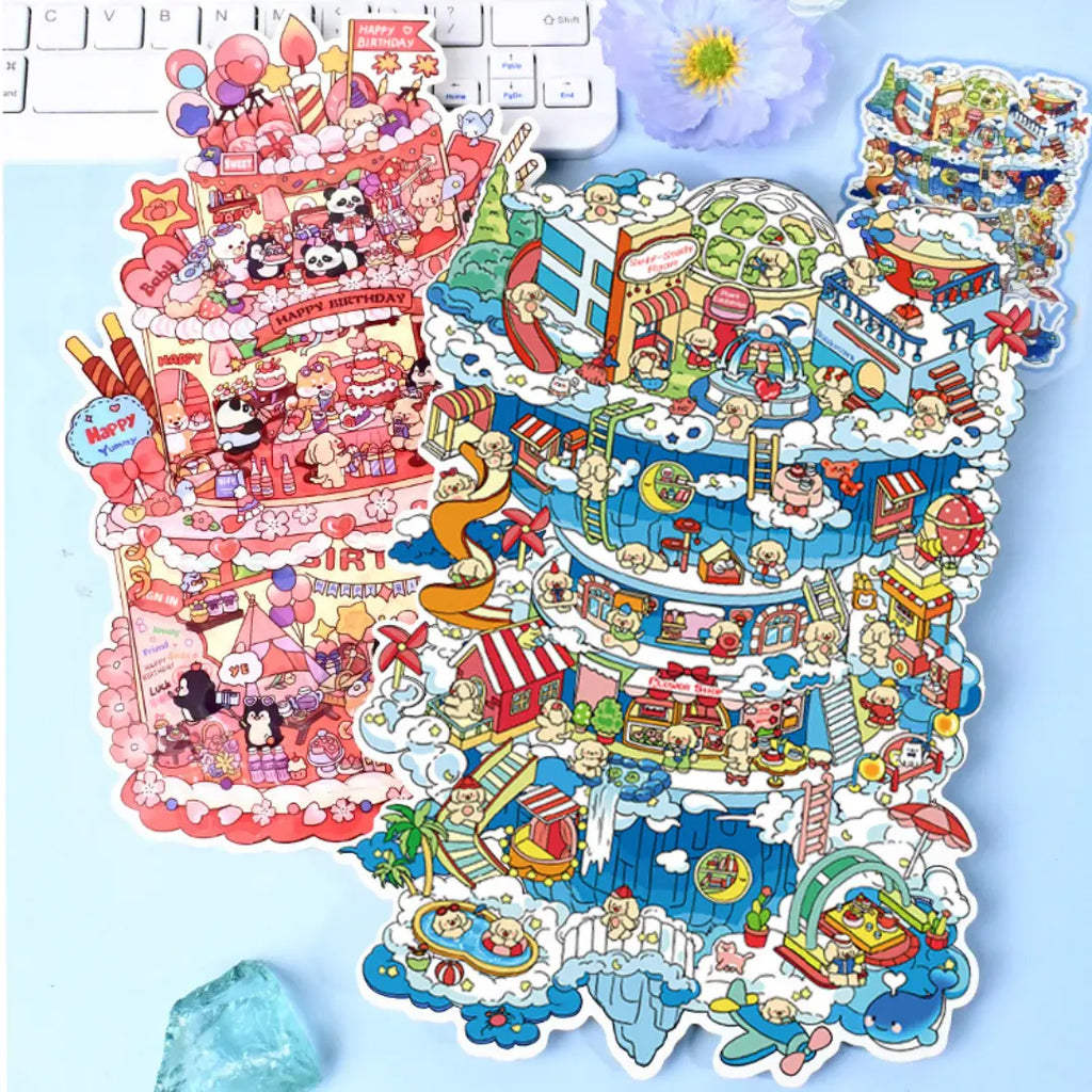 Sky City and Happy Birthday 3D-look scene sticker kits displayed together on a blue desk