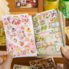 Open Snack Notes sticker book showing pink dessert stickers and green fruit dessert stickers inside the mini sticker book