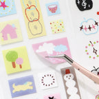 Close-up of a pastel cloud PET sticker being lifted from the Soft Scripts Journaling Sticker Book