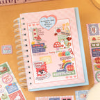 Pink journal page decorated with rainbow, animal, mushroom, fruit, and message stickers from the Stitch collection
