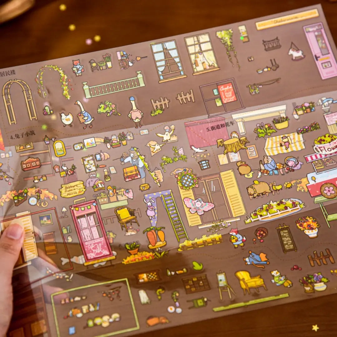 Close-up of Tail Street Never Sleeps PVC sticker sheet with windows, signs, plants, street decor, and small town details