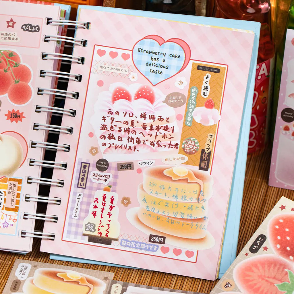 Pink journal page decorated with strawberry cake, pancake, handwritten notes, and dessert stickers