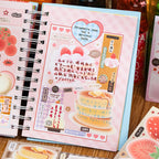 Pink journal page decorated with strawberry cake, pancake, handwritten notes, and dessert stickers