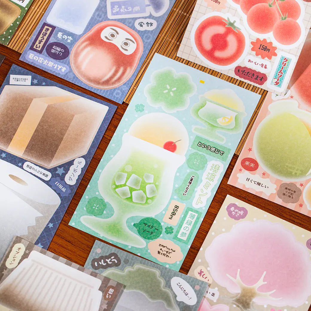 Close-up of Tasty Time sticker sheets with melon soda, tomatoes, peaches, sweets, and soft pastel memo shapes