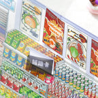 Close-up of frosted PET stickers layered onto the convenience store scene card with snack shelf details