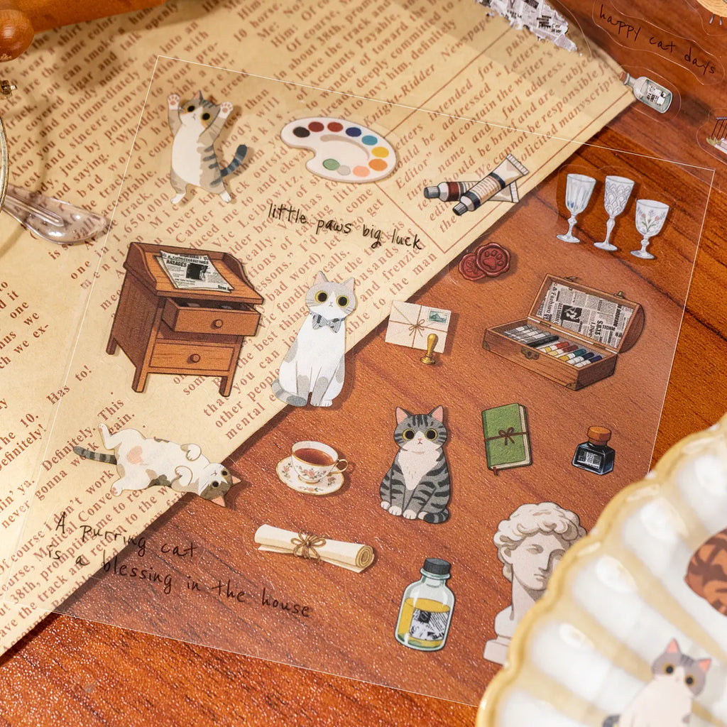 Close-up of Vintage Elegance cat stickers with vintage desk items, tea, art supplies, and cats