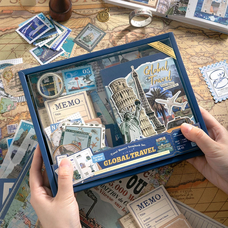 Packaged Warm Postal Journey Junk Journal Kit with travel-themed papers, cards, stickers, and ephemera visible in the box