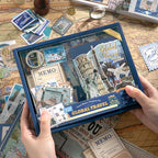Packaged Warm Postal Journey Junk Journal Kit with travel-themed papers, cards, stickers, and ephemera visible in the box