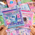 Close-up of a Y2K retro tech and gadgets journaling sticker book set with pink and blue cover designs